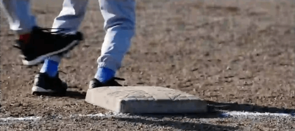 A close play at first base during a youth baseball game.