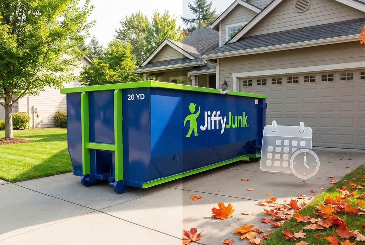 20 yard roll off dumpster in residential driveway with fall leaves and booking calendar icon