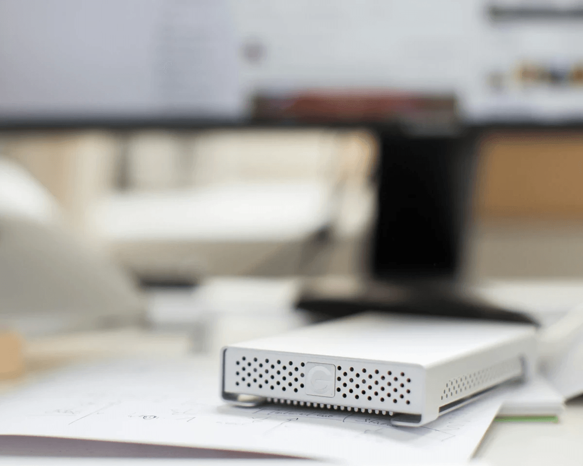 Photo of an external hard drive on a desk next to a description of the measurement and design service.