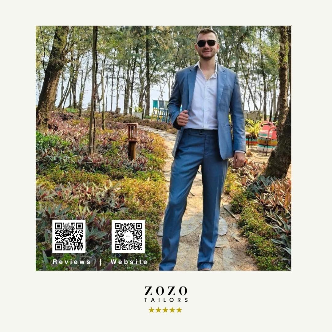 Classic blue suit: crisp shirt	Person wearing a mid-blue tailored suit with a crisp white shirt