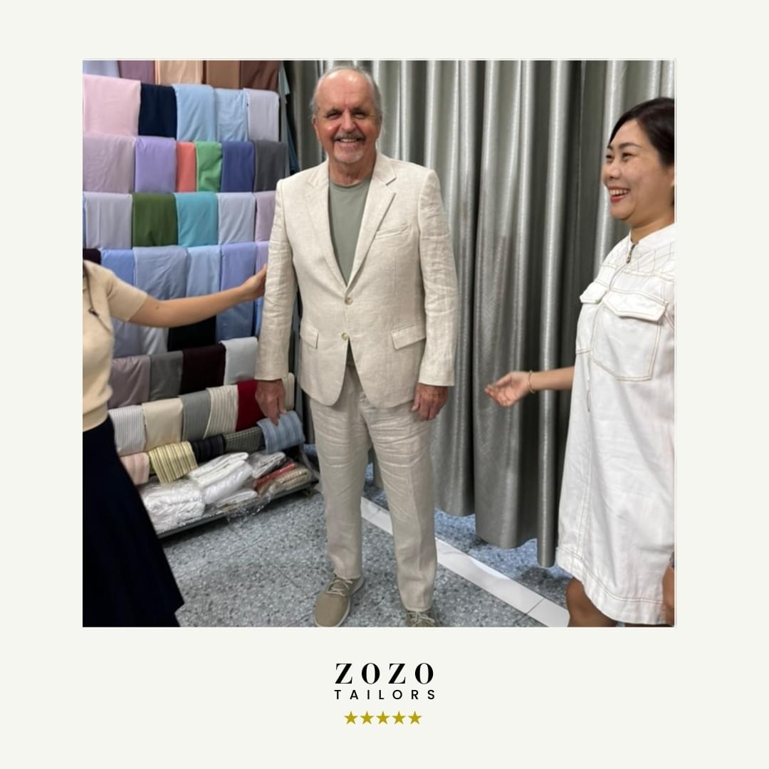 Client and tailor during final fitting of bespoke linen suit.