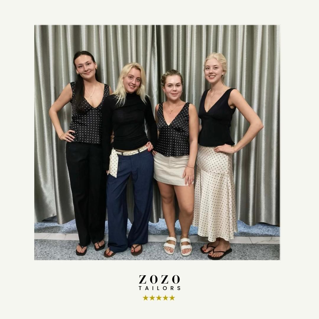 Four clients wearing tailored outfits made in Hoi An, standing together at ZoZo Tailors