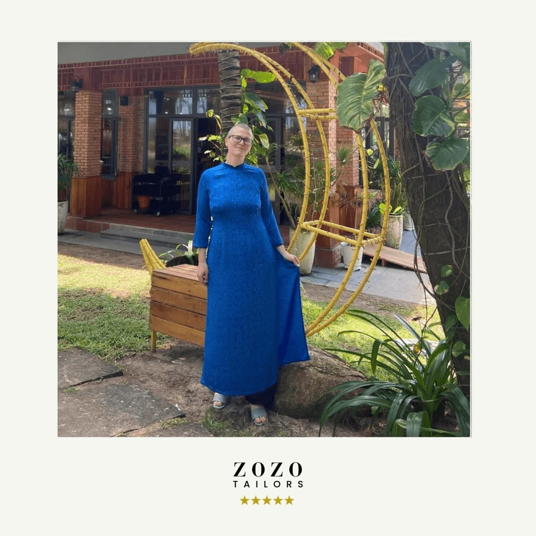 Person wearing a lapis blue silk áo dài (traditional Vietnamese dress)