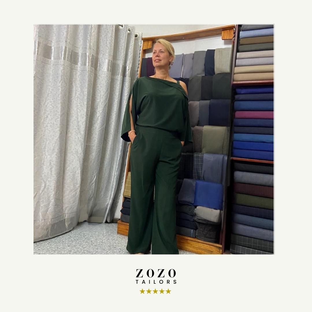 Person wearing a dark green tailored silk set (leisure-wear, top and resort style pant)