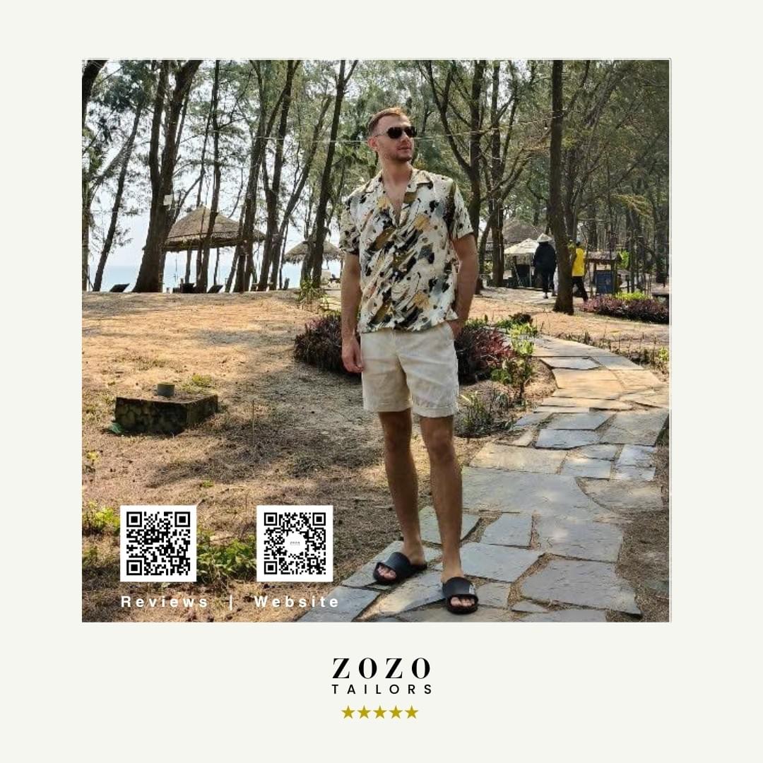 Person wearing patterned shirt with light tailored shorts for leisure wear