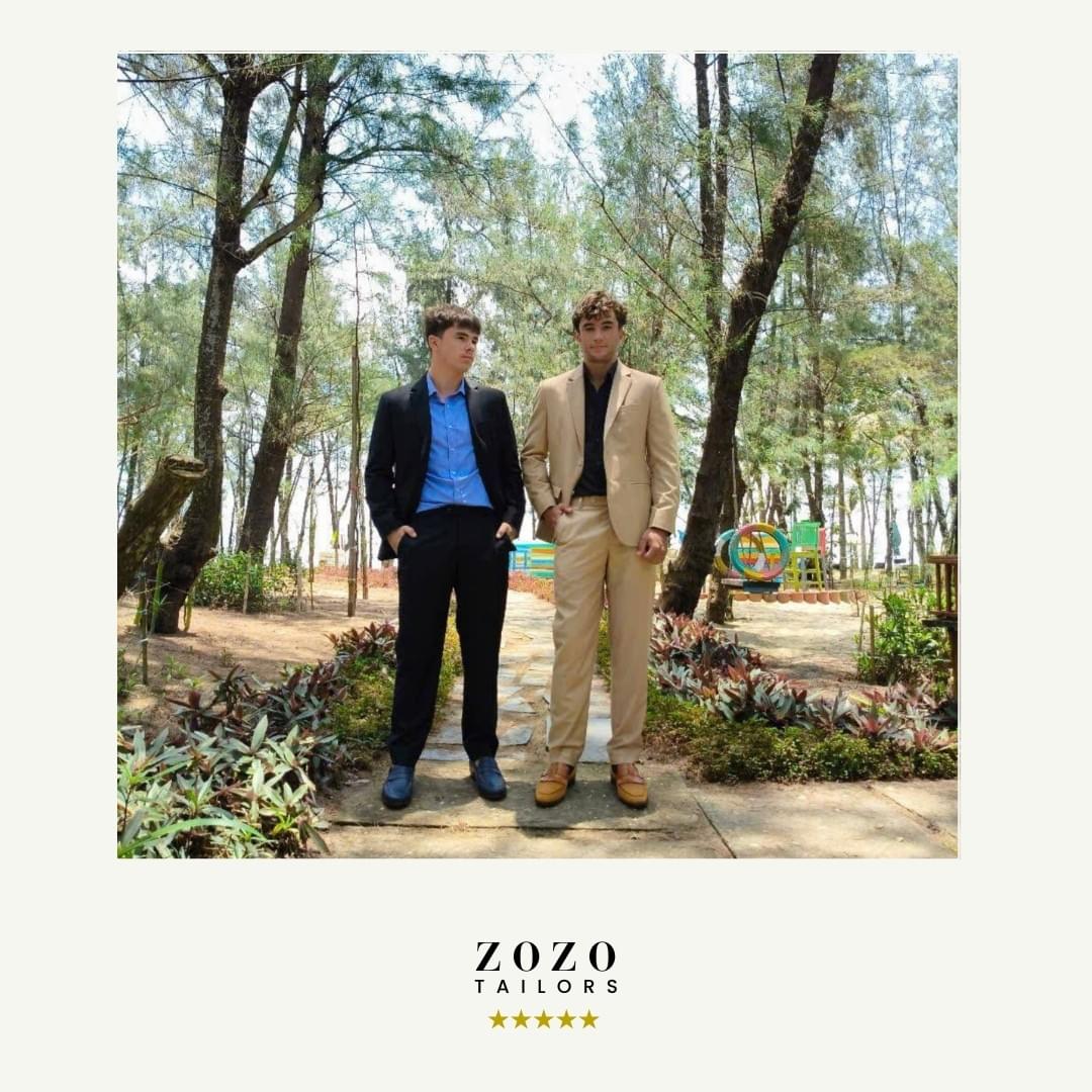 Two young men in a garden setting near tAn Bang beach , Hoi An, wear new suits and shirts, chosen whilst on vacation.