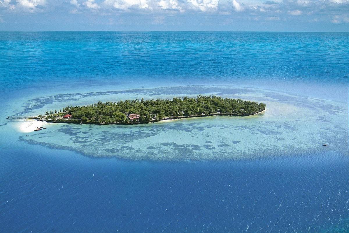 A small portion of island with few buildings on it's coast