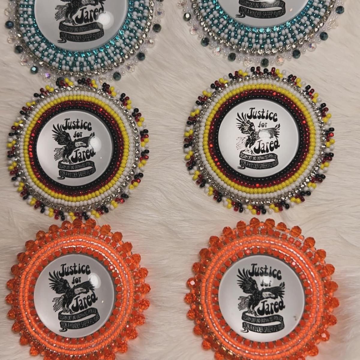 3 pairs of beaded earrings with a “Justice For Jared” can in the centre.