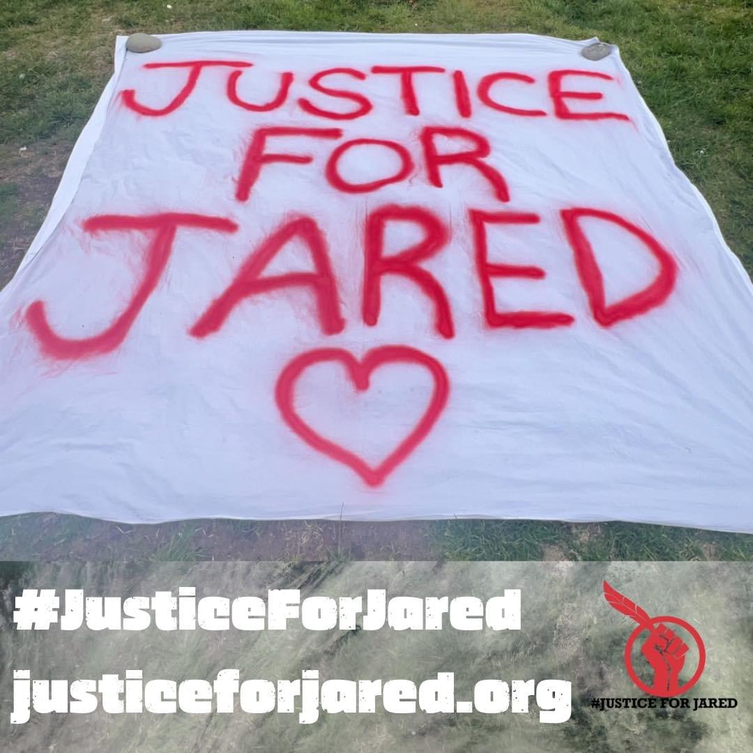 White banner that says "Justice for Jared" in red with a heart
