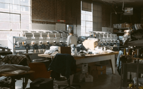 SNAG Collective production studio with commercial embroidery machines crafting custom hats and apparel. SNAG Collective production studio with commercial embroidery machines crafting custom hats and apparel.