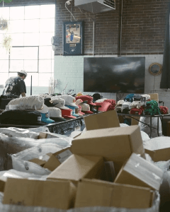 SNAG Collective warehouse featuring custom embroidered hats, apparel, and order fulfillment workspace. SNAG Collective warehouse featuring custom embroidered hats, apparel, and order fulfillment workspace.