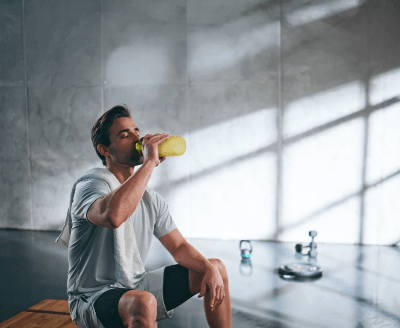 Man drinking an Almased nutrition shake after exercise to support fitness, recovery, and healthy living