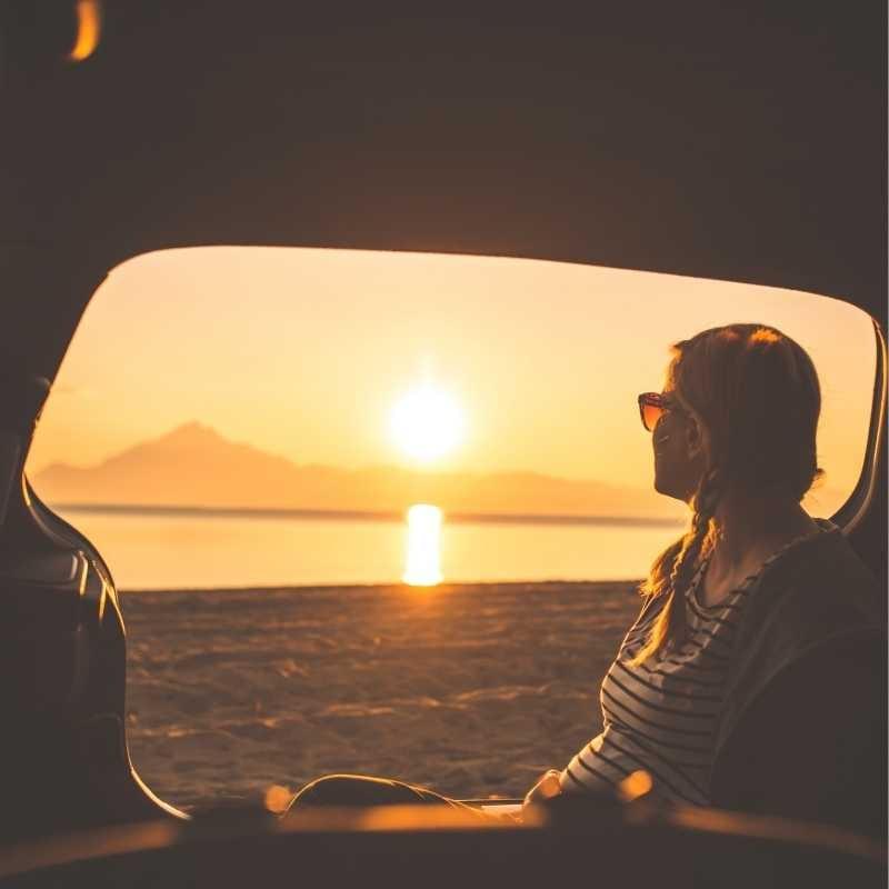 Woman looks out of a safari tour bus in Africa Woman looks out of a safari tour bus in Africa