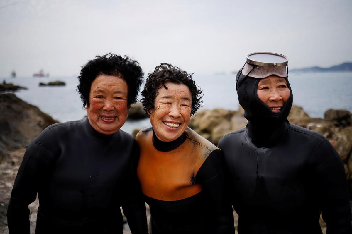 Sea-Women: Jung Sun-ja, 84, Yoon Yeon-ok, 74, and Ko Keum-sun, 69 - For most of the haenyeo, diving seems to be a decisive factor for their wellbeing. Through physical activity they avoid the dangers of a sedentary lifestyle. They feel vital and useful and can be together with people they have known all their life. Haenyeo, or "sea women,” come from a long diving tradition. They can dive as deep as 20 meters , they gather as much as they can carry and place it in floating nets. The divers say they see their work as more than just a job; it’s a way of life that keeps them connected to the ocean. However, this centuries-old practice may be coming to an end as climate change transforms the ocean. 