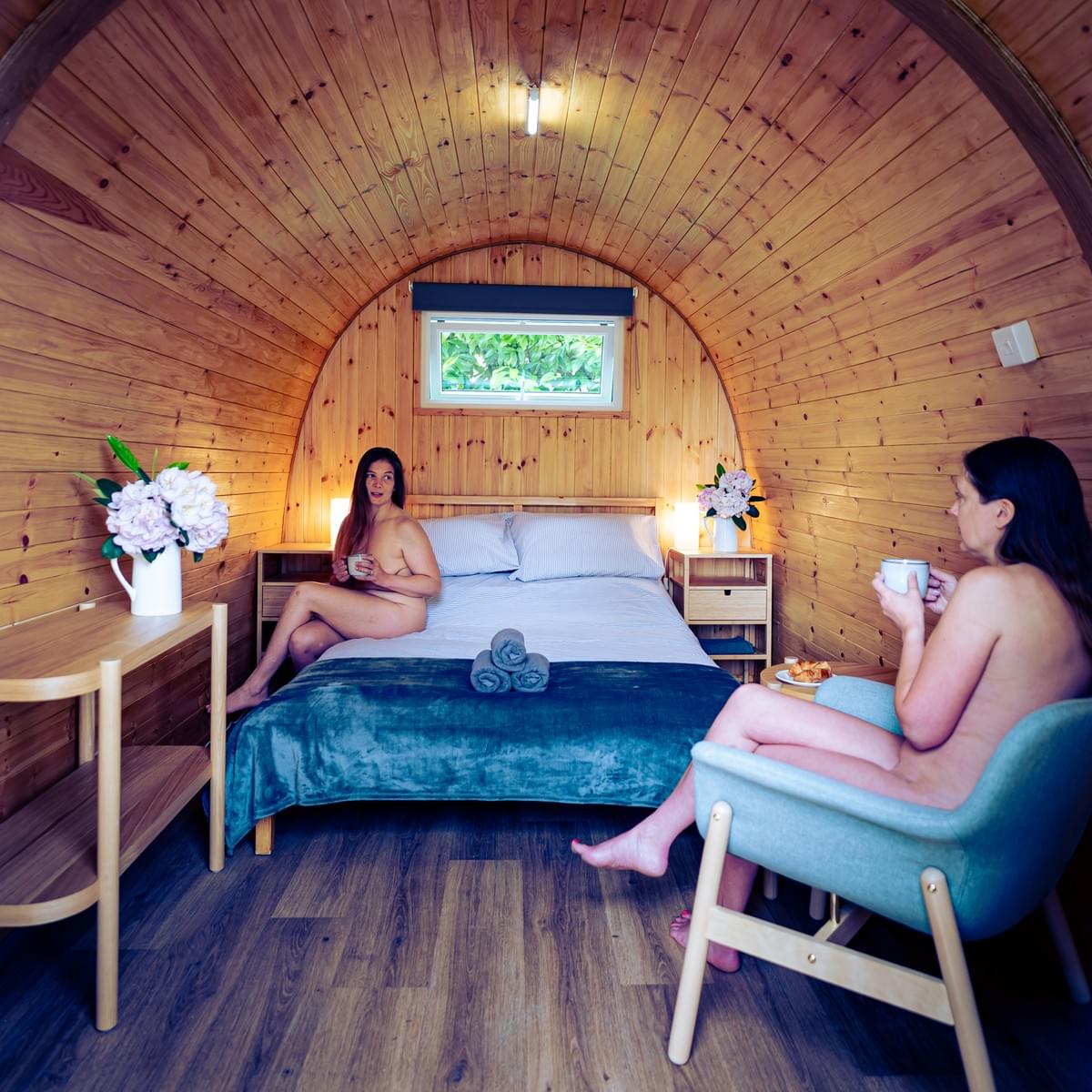 A couple enjoying a cup of tea in their glamping pod