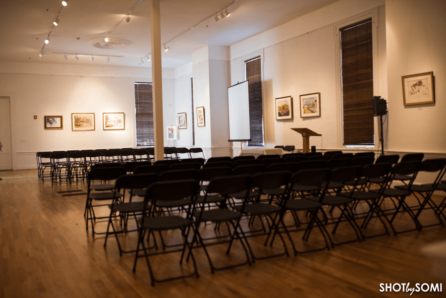The main gallery of the Beach Institute with rows of folding chairs and a lectern.