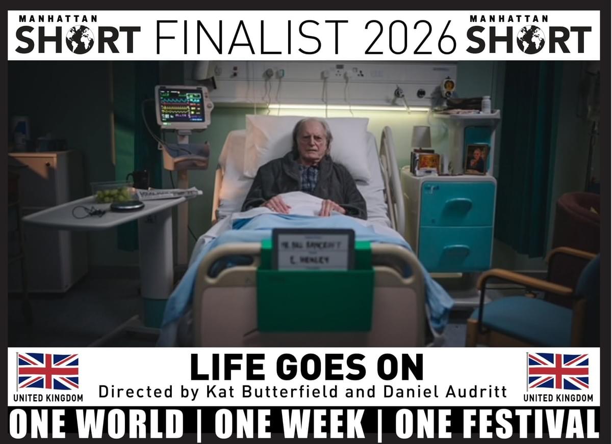 Film festival poster for Manhattan Short Finalist 2026, promoting short film “Life Goes On,” directed by Kat Butterfield and Daniel Audritt. Hospitalized older man appears in bed beside medical equipment, with United Kingdom flags and slogans “One World | One Week | One Festival.” Film festival poster for Manhattan Short Finalist 2026, promoting short film “Life Goes On,” directed by Kat Butterfield and Daniel Audritt. Hospitalized older man appears in bed beside medical equipment, with United Kingdom flags and slogans “One World | One Week | One Festival.”