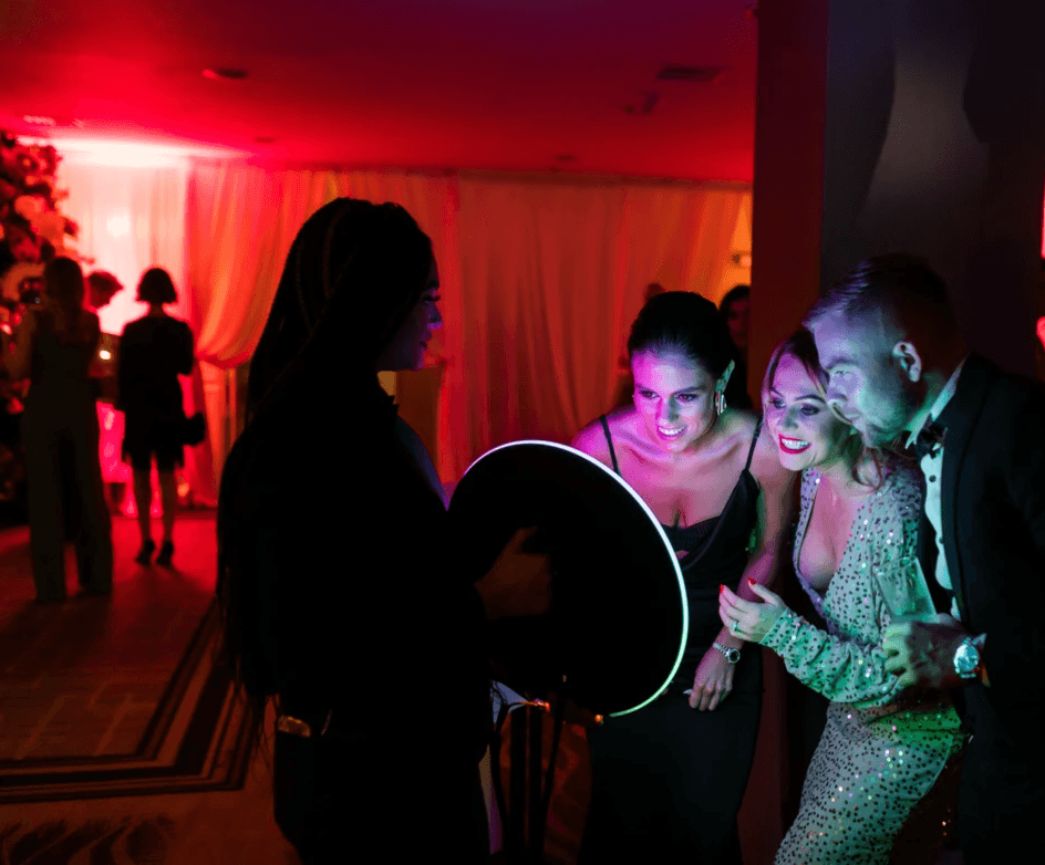 Guests gathered around a roaming photo booth screen, reacting to photos in real time during a lively event with 360 Photo Booth Indianapolis.