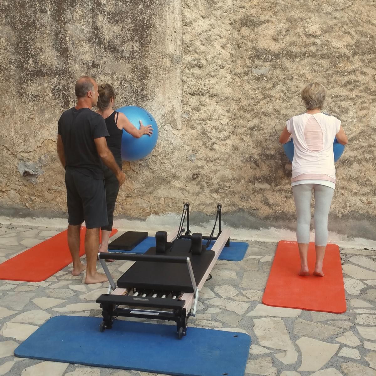 Our Pilates instructor teaching functionality in the outdoor garden Our Pilates instructor teaching functionality in the outdoor garden
