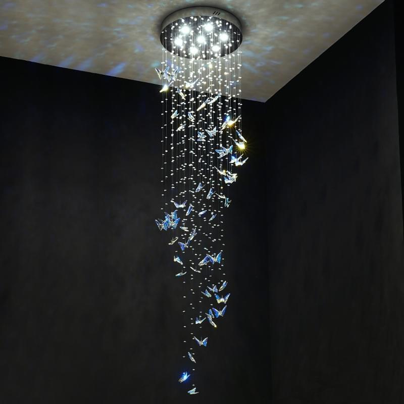  Elegant crystal butterfly chandelier hanging in a modern stairwell with high ceiling