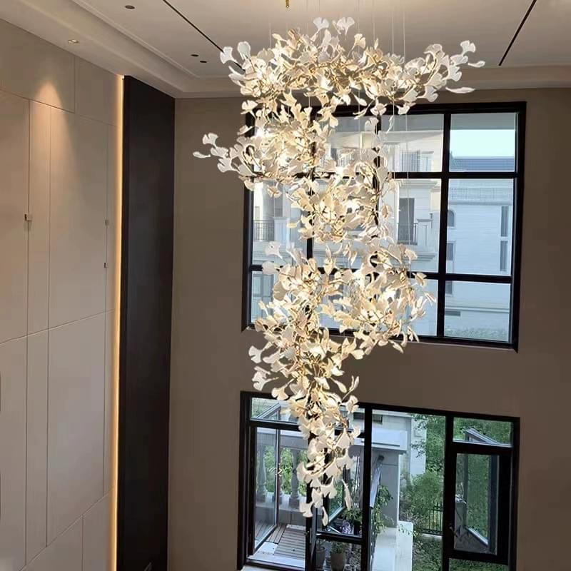 Ginkgo leaf chandelier with ceramic finish for elegant stairwell lighting.
