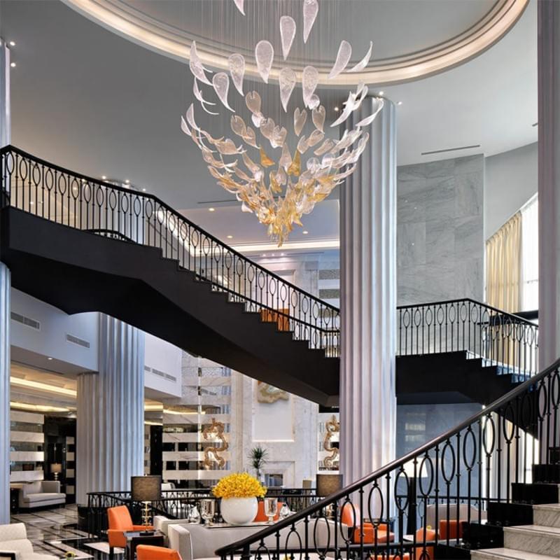 Custom colorful art glass chandelier in a modern hotel lobby