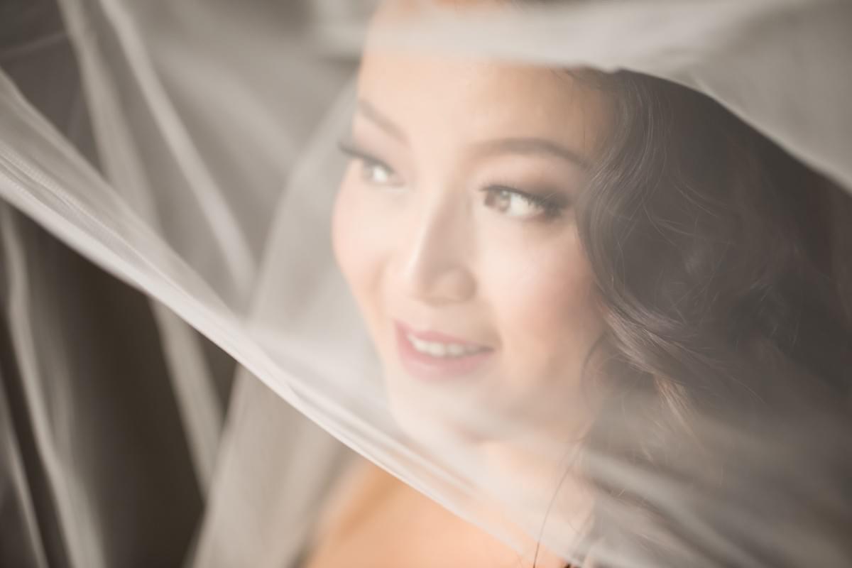 Bride with classic style makeup and veil over the face