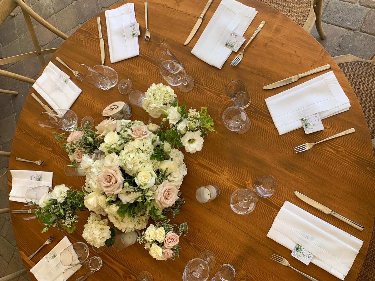 Top view of a table display for a wedding feature white and blush floral arrangement