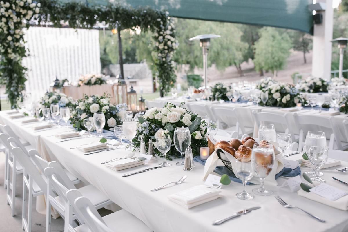 White and greenery classic wedding table design setup, low centerpieces