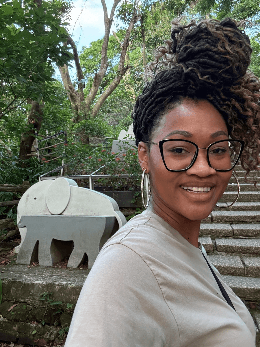 Selfie of Brit Thompson of Cultures Uncovered in front of the Elephant stairs entrance of Elephant Mountain hiking