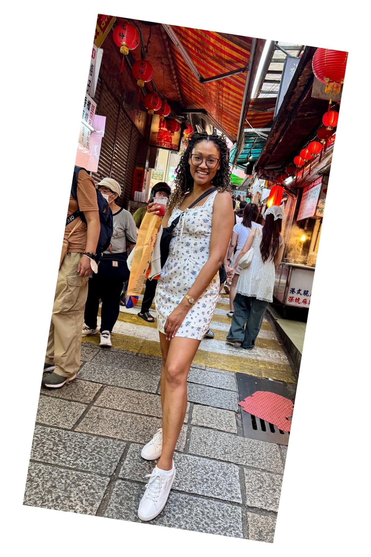 Brit Thompson in front of the Jiufen Old Street Market walkway with the most wonderful and refreshing cranberry and lime slushie
