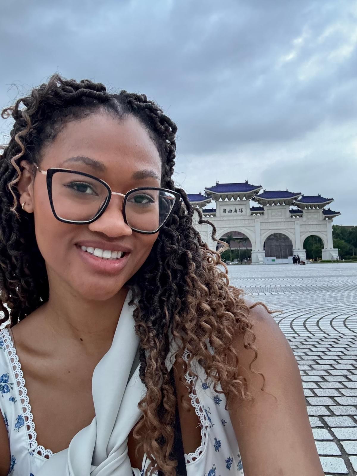 Brit Thompson sitting in front of the gates at the Chiang kai-shek Memorial Hall tiles