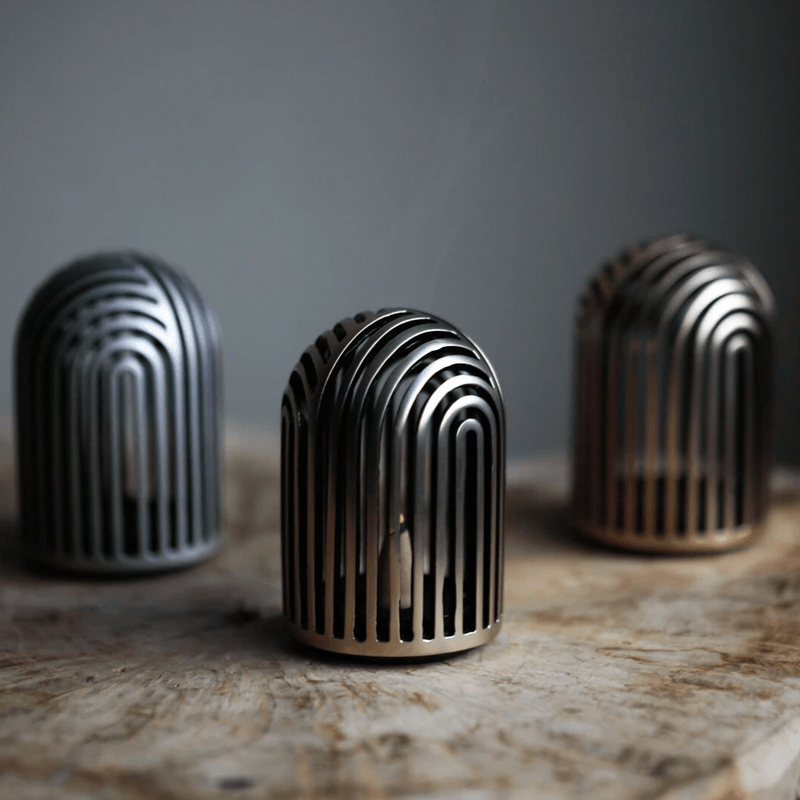 Zen-inspired incense burner with hand-hammered bronze texture and soft golden hue.