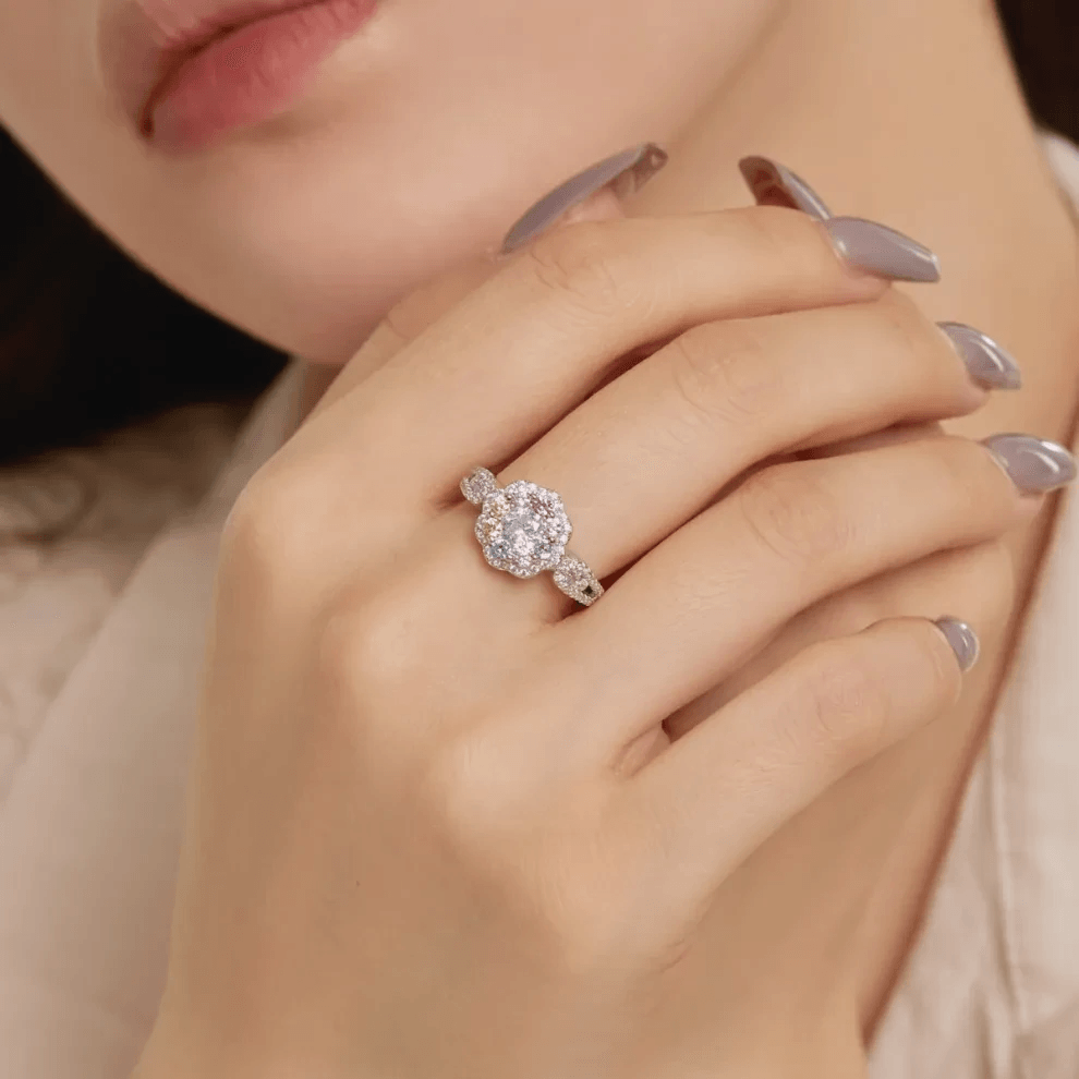 Elegant hand wearing sparkling blue color moissnaite ring