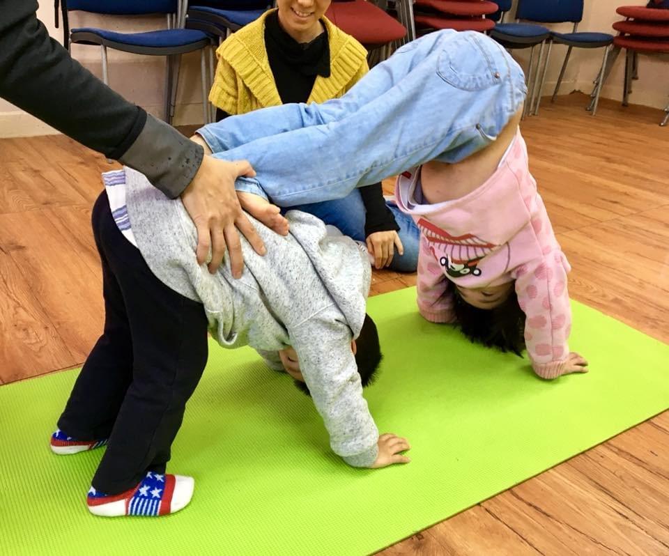 Downward dog and handstand prep as demonstrated by toddlers here at Mulberry Tree