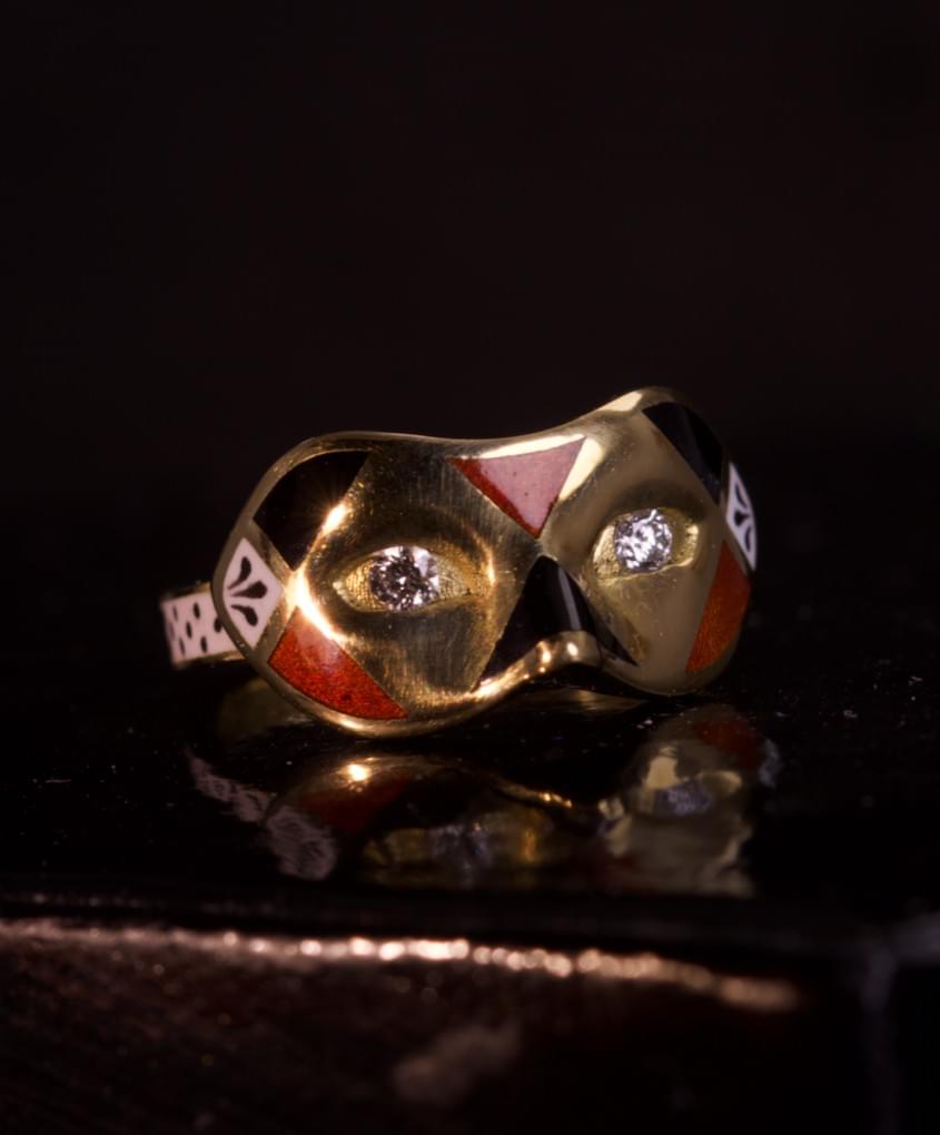 A diamond, enamel and gold mask ring