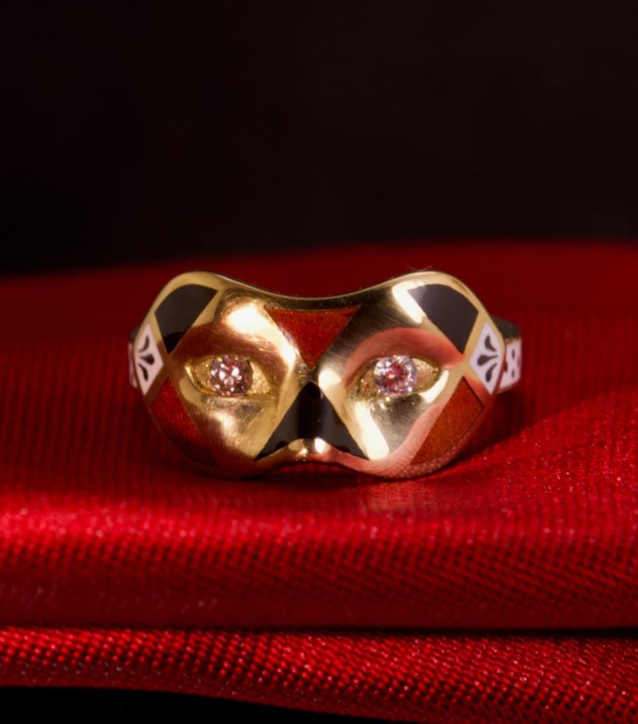 A diamond, enamel and gold mask ring