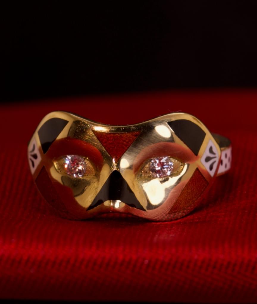 A diamond, enamel and gold mask ring