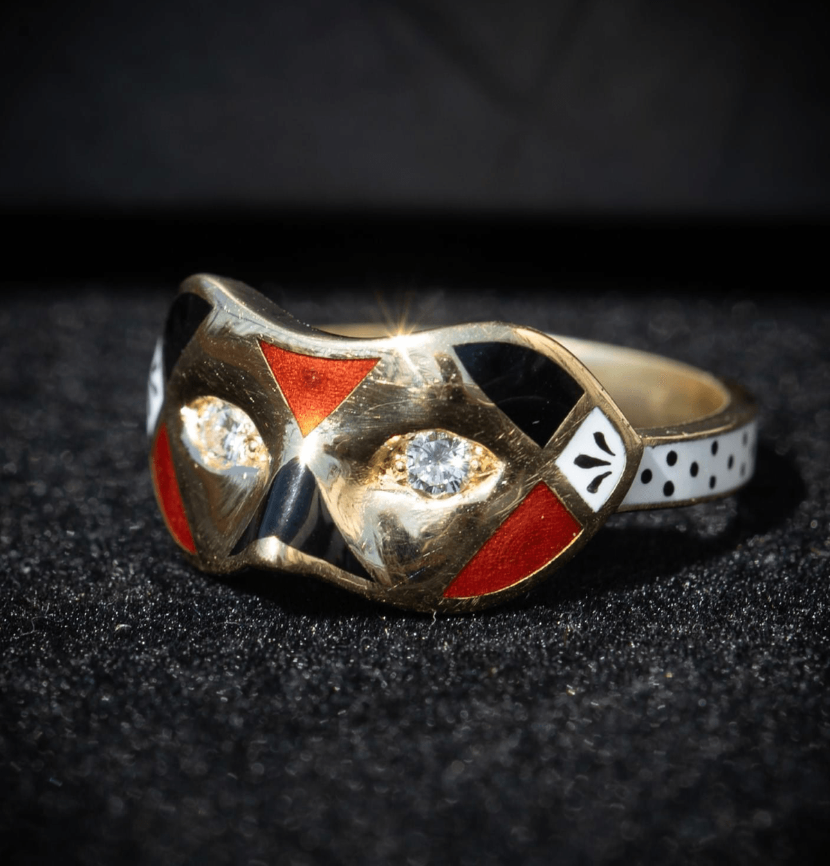 A diamond, enamel and gold mask ring