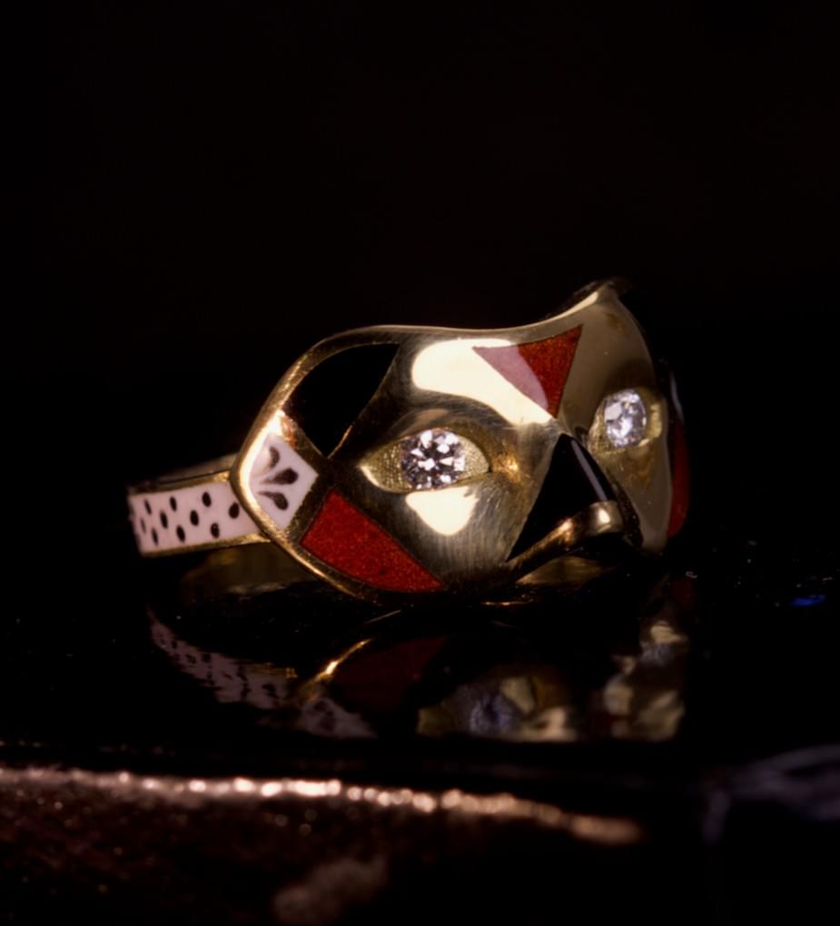 A diamond, enamel and gold mask ring
