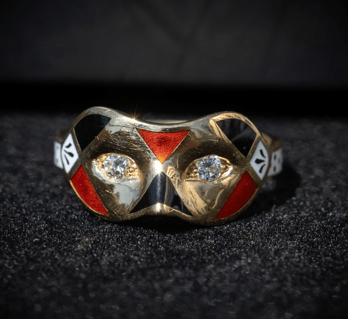 A diamond, enamel and gold mask ring