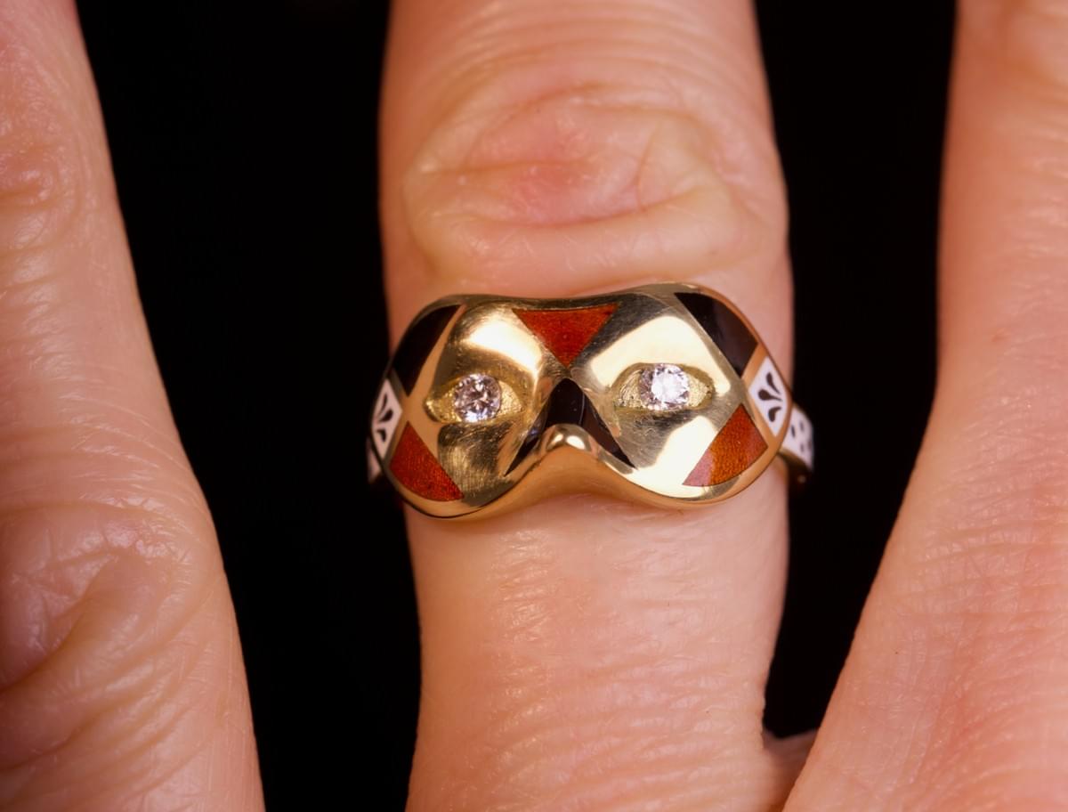 A diamond, enamel and gold mask ring