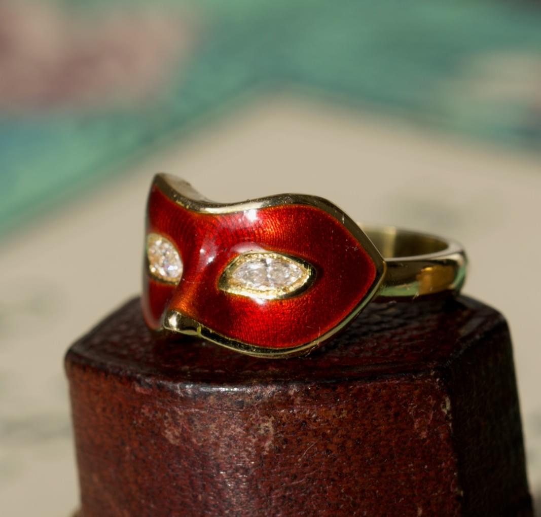 A diamond, enamel and gold mask ring