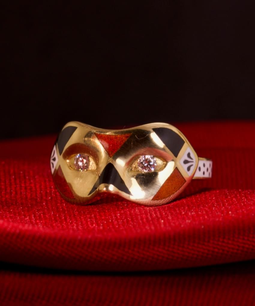 A diamond, enamel and gold mask ring