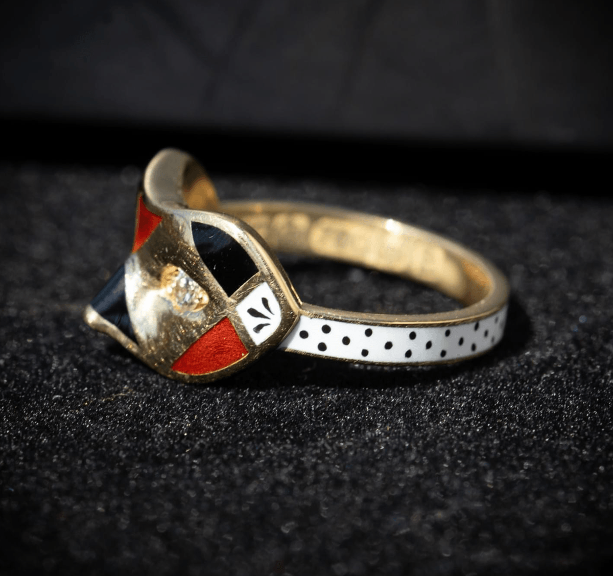 A diamond, enamel and gold mask ring