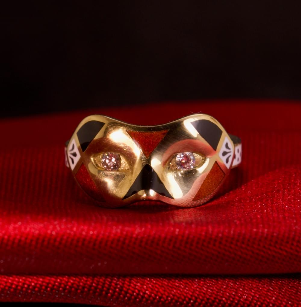 A diamond, enamel and gold mask ring