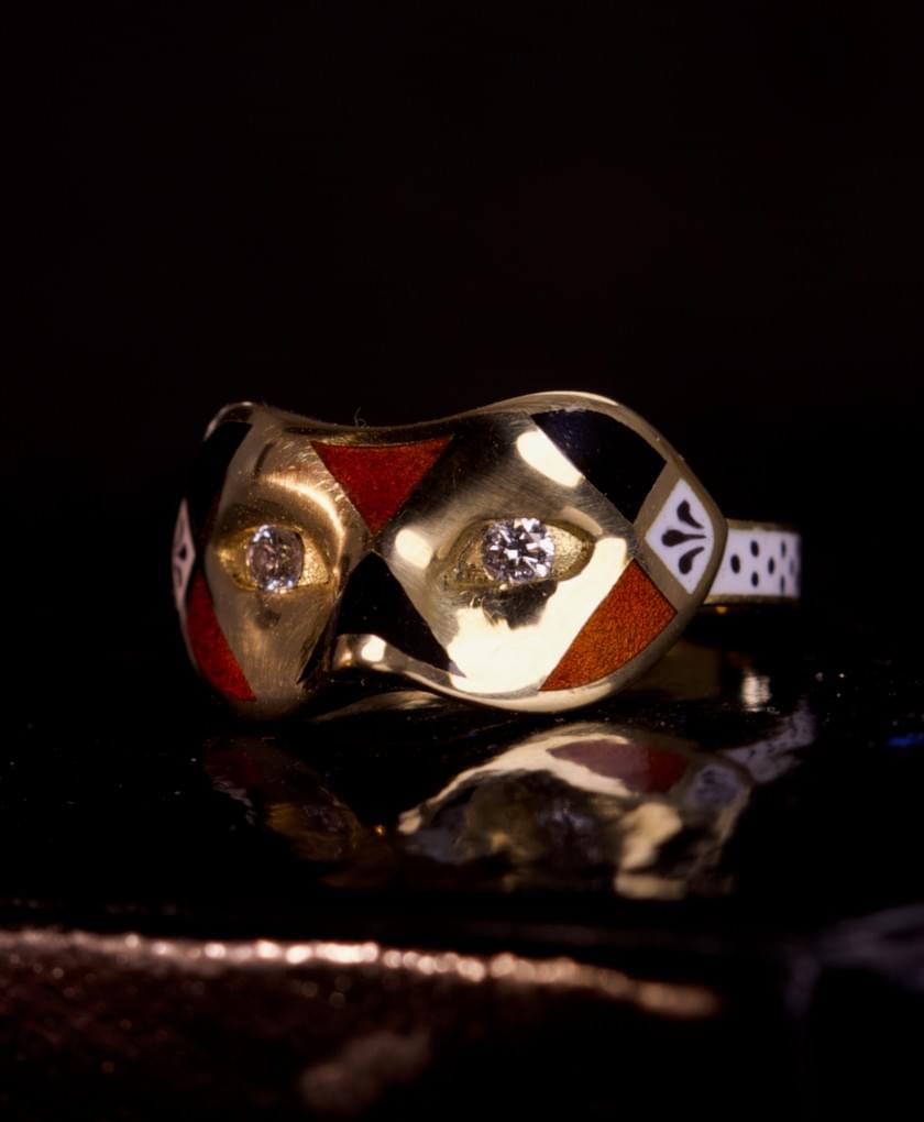 A diamond, enamel and gold mask ring