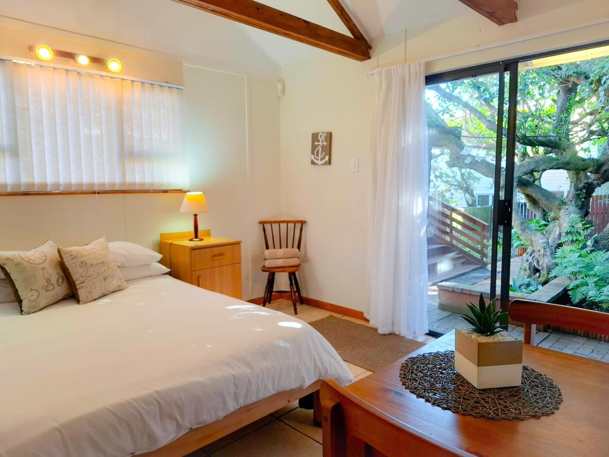 Friends enjoying barbecue with stunning sea views.