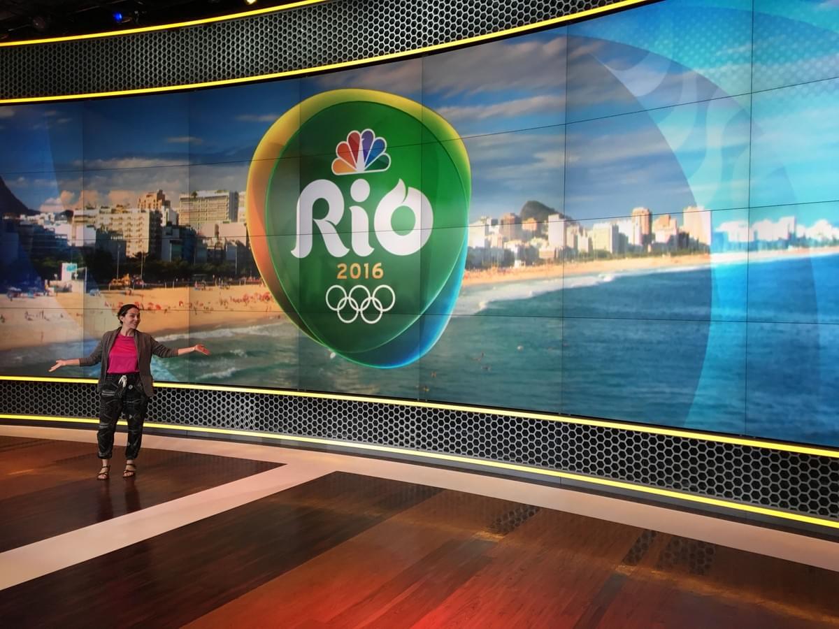woman in front of Rio Olympics sign