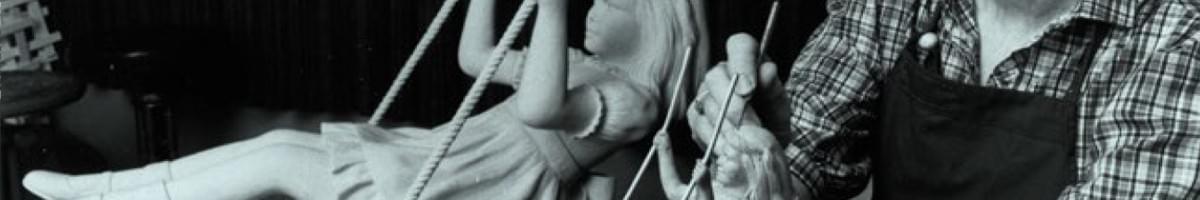 Photo of artist painting minature Heather statue.